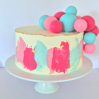 Cake with colorful ball decorations on a white background