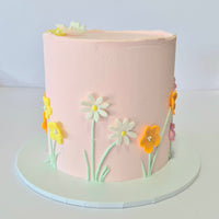 Pink cake with floral decorations on a white background