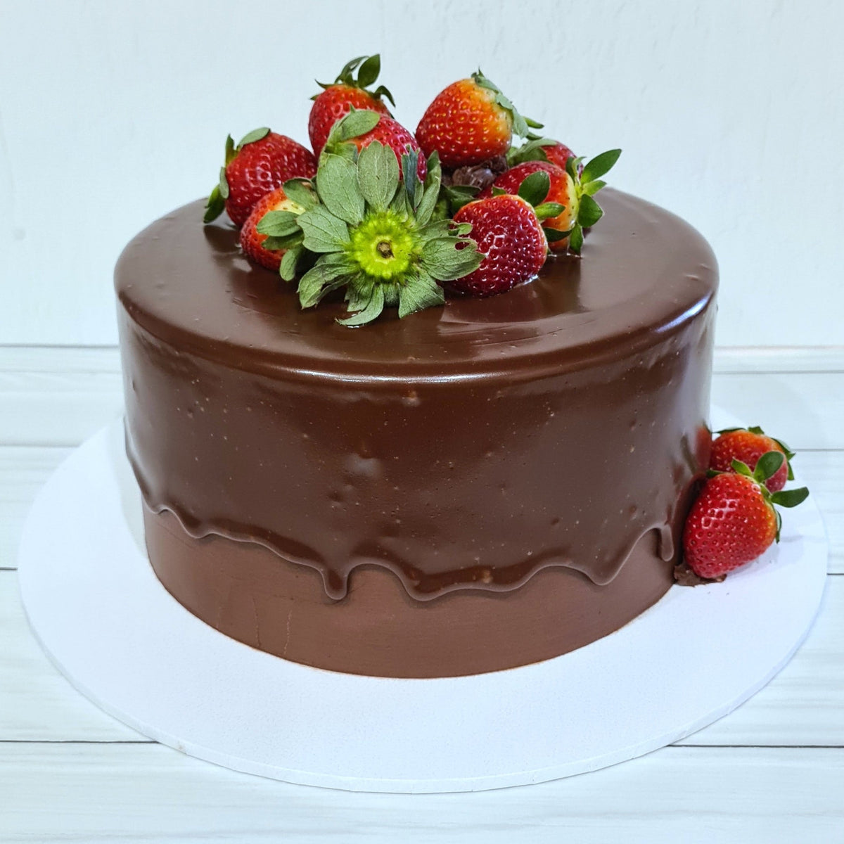 Chocolate cake with strawberries on a white background