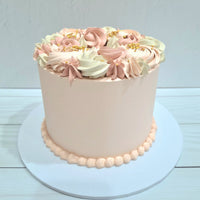 Pink cake with floral decorations on a white background